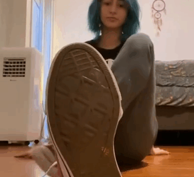 Emo girl gets off her shoes and socks showing feet